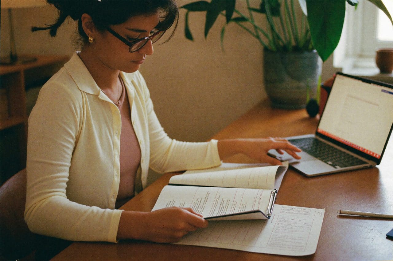 An advisor reviewing a client report at a sunlit desk
